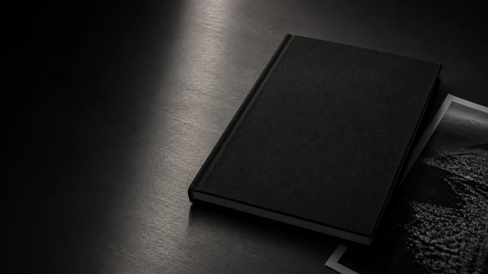 A restrained black field report under a narrow beam of light